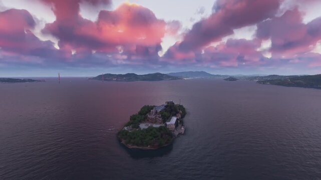 Circular aerial drone shot at sunset of Alcatraz Island in San Francisco. California. United States