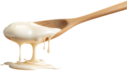 Condensed milk flowing down from spoon isolated on transparent white background,