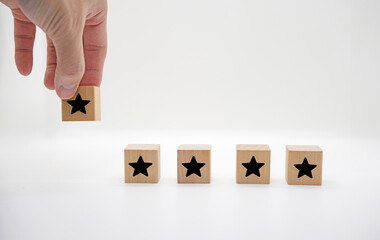 Hand Adding Star Rating on Wooden Blocks