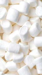 Close-up of fluffy, white marshmallows creating a dense, sweet, creamy texture pattern