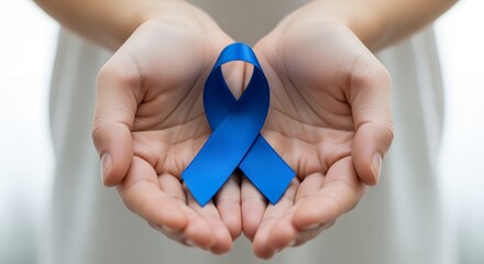 Hands gently holding a blue awareness ribbon, symbolizing various causes and support.