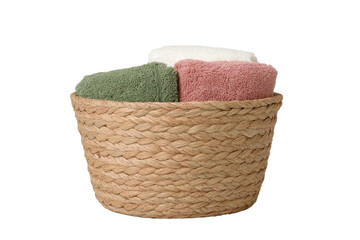 Towels stacked in woven basket, green, pink, & white cloths