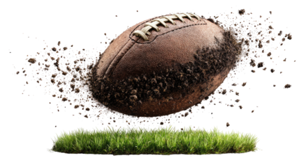 Football soars, scattering dirt above grass