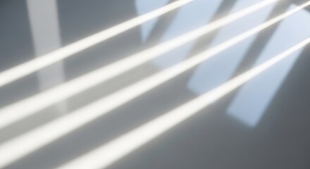 Sunlight streaming through window blinds casting shadows on a smooth surface in a modern interior setting