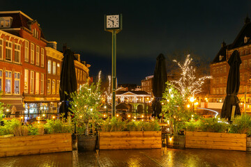 Illuminated Koornbrug bridge and clock square with Christmas lights in Leiden Netherlands at night