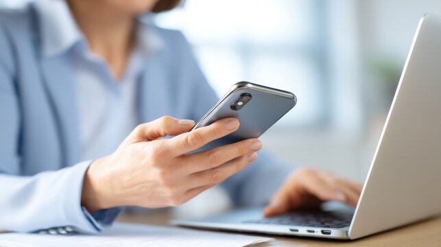 Using smartphone and laptop for business communication home office digital interaction modern workspace professional engagement