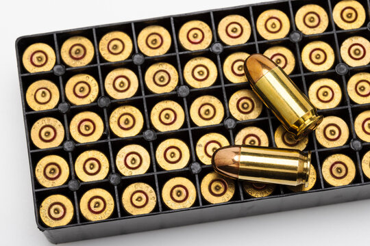 .45 ACP bullet pistol gun with ammunition box on white background