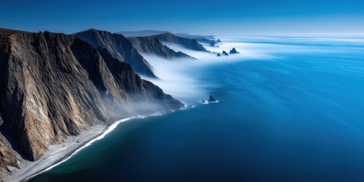 Vista Coastline Natural wonder concept. Aerial view of cliffs and ocean with mist in a serene landscape.
