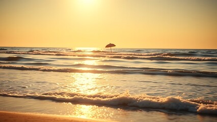 Sunny beach with gentle waves and a single umbrella under warm golden hour light.