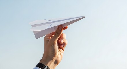 Holding White Paper Airplane Up to Blue Sky