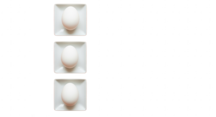Three fresh white chicken eggs neatly arranged on square plates, perfect for breakfast themes.