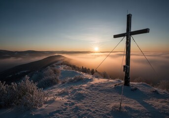 Wooden Cross on Snowy Hill at Sunset