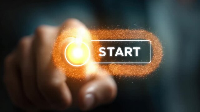 Finger pressing a glowing "START" button with a burst of orange light. Dark background, blurred