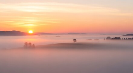 Naklejka premium Sunrise Over Misty Landscape - A Serene Morning Scene.