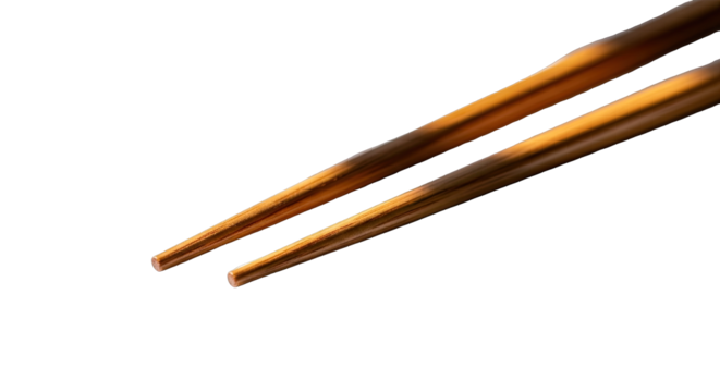 Close Up Of Two Wooden Chopsticks With Textured Grips Illuminated By Warm Sunlight Against A Black Background Ready To Eat Asian Cuisine