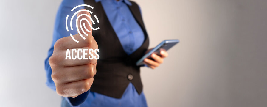 Access via fingerprint. Businesswoman holding a cell phone while pointing with her thumb at a fingerprint icon and the word "Access".
