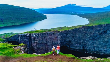 A couple on vacation at the Faroe Islands, Slave Cliff Traelanipa