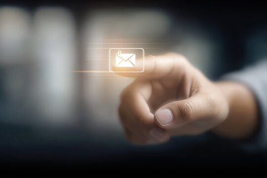 Close up of finger touching email icon on screen for communication concept