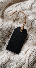 Black tag on a knitted cream sweater with cable knit
