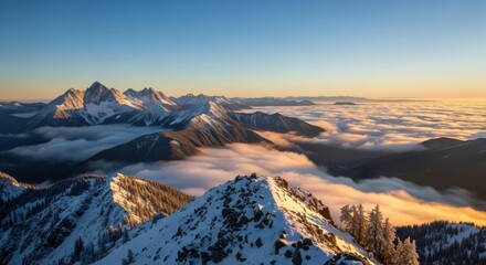 Majestic snowy mountain peaks at sunrise above a sea of clouds