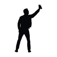 Silhouette of a Graffiti Artist or Man Spraying Paint, Representing Urban Art, Vandalism, or Protest