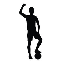 Silhouette of a football/soccer player standing in shorts and cleats, with one foot on the ball and a fist raised in triumph. Represents winning, success, sport, and celebration.
