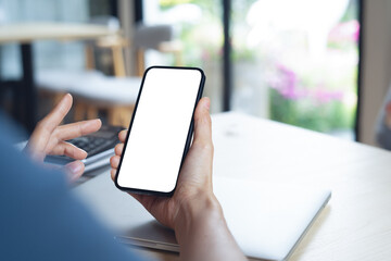 Close up, cell phone blank screen mockup. Woman hand holding, using smartphone with blank white screen mockup for social media marketing or web template design
