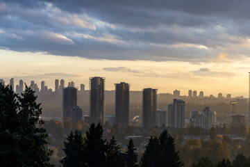 Sunset Over Burnaby Skyline: Towering Towers Rise Above Verdant Trees in Greater Vancouver
