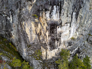 Vertical Granite Cliff Face Dominates Rugged Mountain Terrain Above Forested Valley, BC Canada