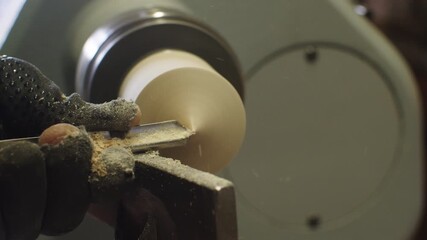 Woodturning machine demonstration of spinning and carving a wooden piece