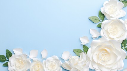 White paper flowers and green leaves arranged on a light blue background handmade craft