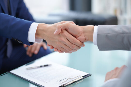 Successful business partnership handshake and contract negotiation for cooperation and agreements sealing the deal with trust and professionalism in the office environment