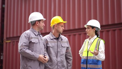 Engineer and worker team working in logistic terminal of container cargo, Diverse construction team in safety gear outdoors - Powered by Adobe