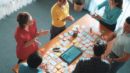 Professional business team shaking hand or making agreement at meeting table with tablet displayed wireframe prototype for mobile phone or computer. Aerial view of team working together. Symposium. - Powered by Adobe