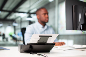 Man Digitizing Paper Documents Using Scanner