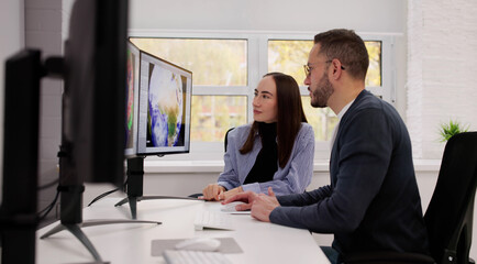 Meteorologists Analyze Weather Data In Office