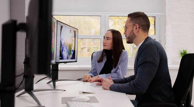 Meteorologists Analyze Weather Data In Office