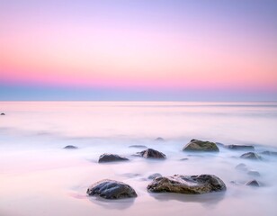 Serene beach scene at sunrise, with smooth water and rocks