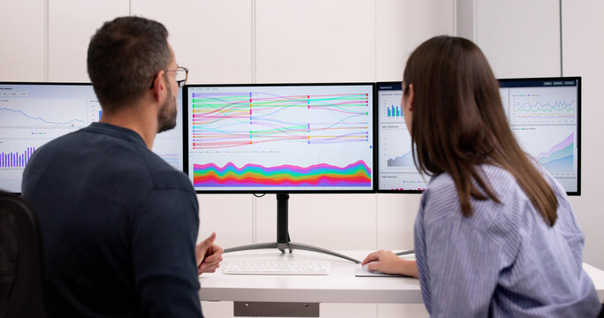 Financial Analyst Examining Sankey Chart Dashboard On Computer Screen