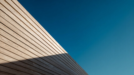 Natural wood siding against a clear blue sky architecture clean