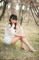 An Asian beauty wearing a lace dress in the garden