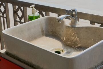 The old sink has scale buildup.