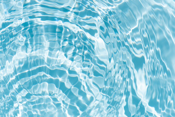 Blue water with ripples on the surface. Defocus blurred transparent blue colored clear calm water surface texture with splashes and bubbles. Water waves with shining pattern texture background.