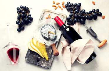 Bottle and glasses of red wine with snacks. Party concept.