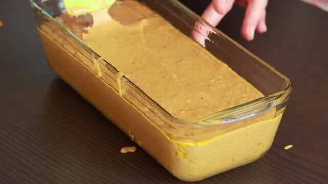 raw pumpkin bread batter in loaf pan ready for baking