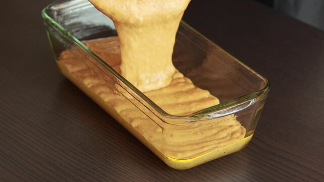 raw pumpkin bread batter in loaf pan ready for baking