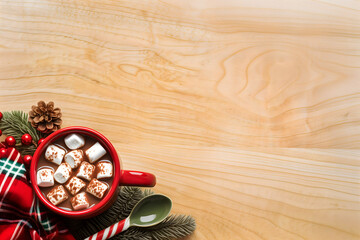 Festive Christmas flatlay with gift boxes and pine decorations on wooden background