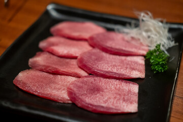 Japanese style sliced rare beef tongue meat on the plate