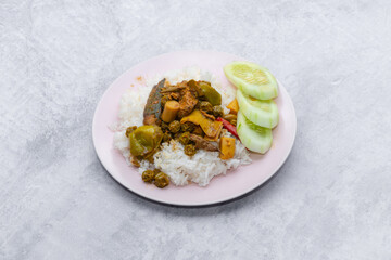 Thai food stir fried with spicy curry paste With different kinds of meat topped on cooked rice