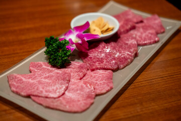 Various type of Japanese style sliced rare beef meat set on the plate, soft focus